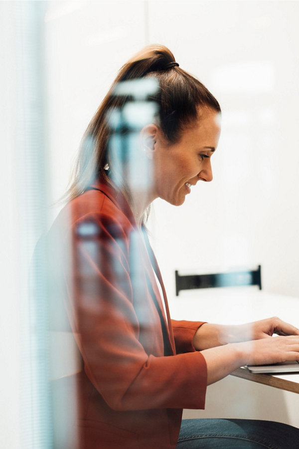 Woman typing in meeting room