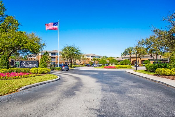 Scenic courtyard view at Villas at Gateway Apartments featuring lush greenery and outdoor seating