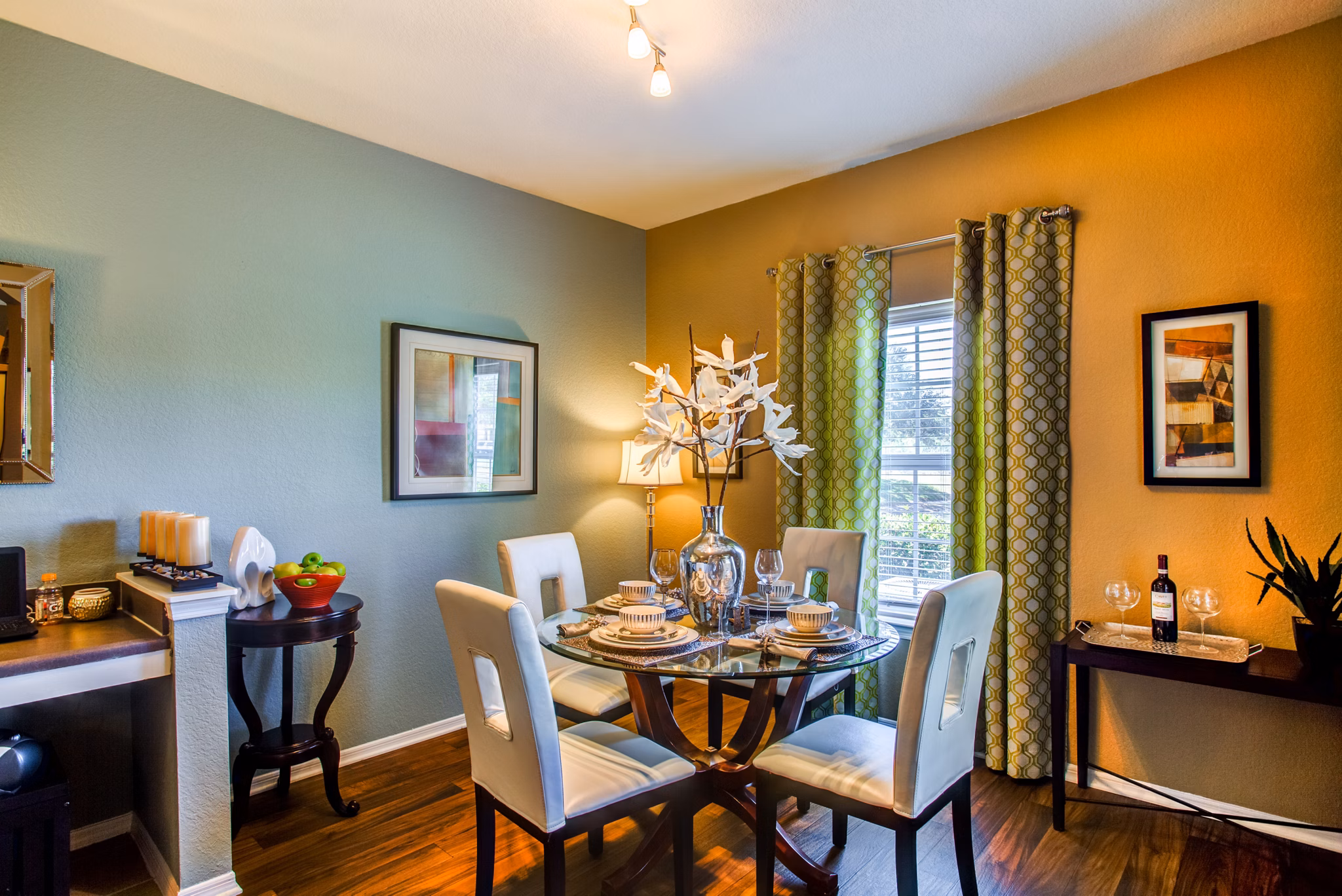 Dining area with elegant lighting and modern furniture at Villas at Gateway Apartments