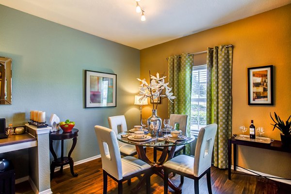 Dining area with elegant lighting and modern furniture at Villas at Gateway Apartments