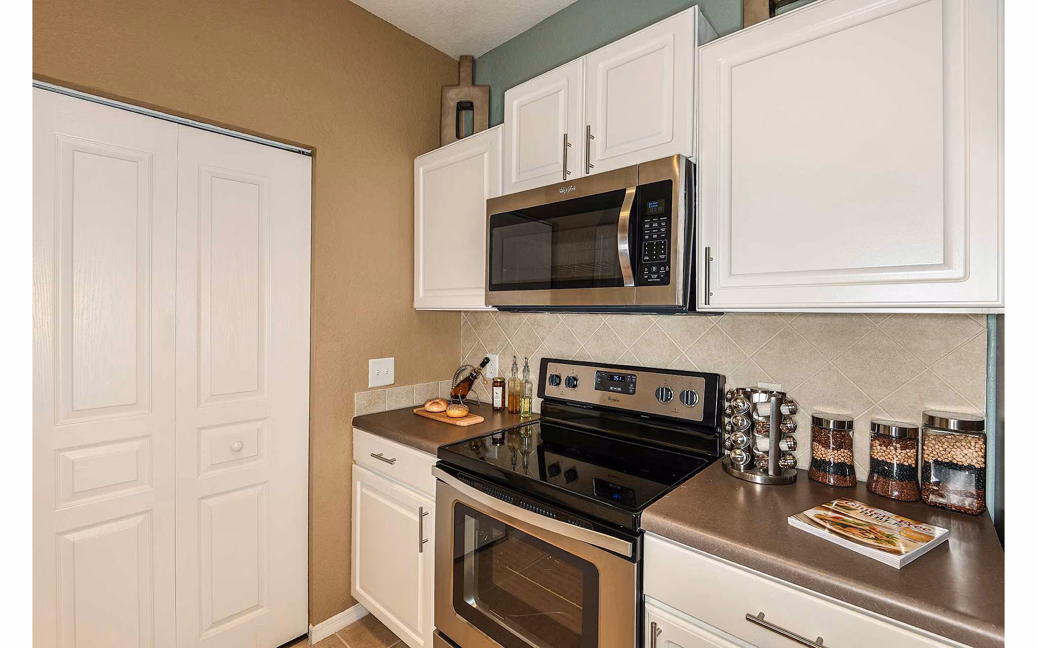 Modern kitchen with stainless steel appliances at Villas at Gateway Apartments