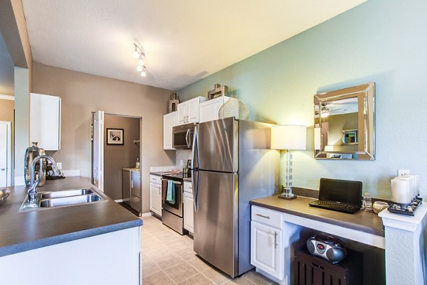 Modern kitchen featuring stainless steel appliances at Villas at Gateway Apartments