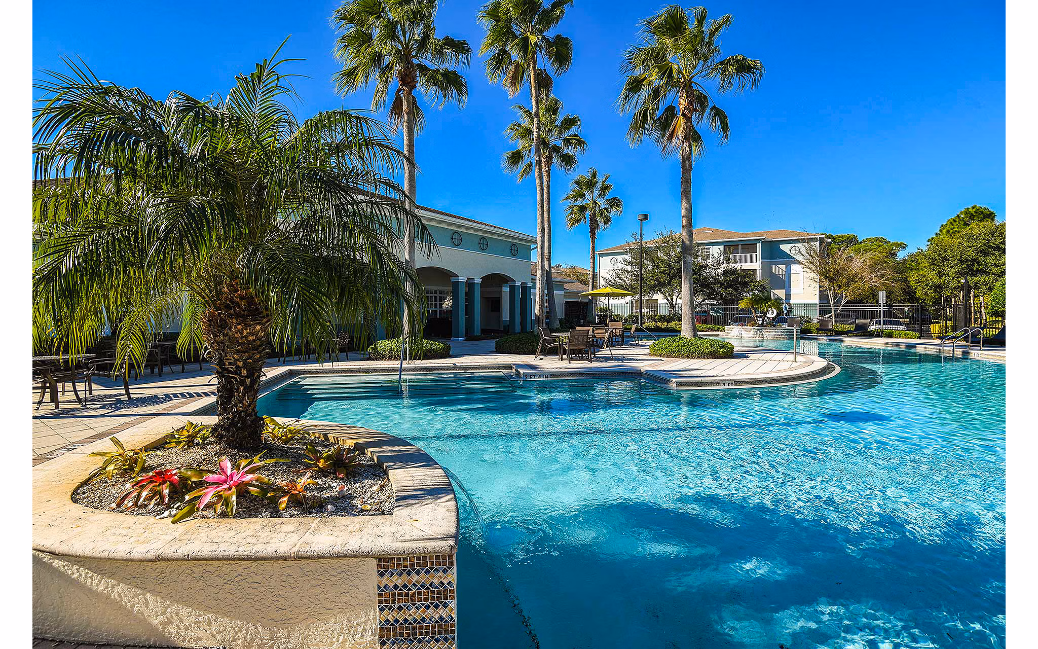 Resort-style pool with sun loungers at Villas at Gateway Apartments