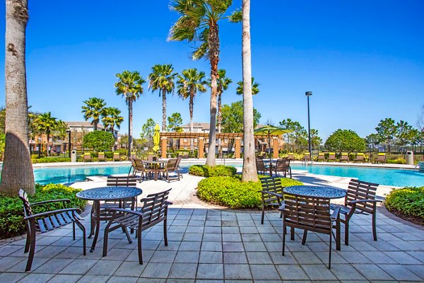 Villas at Gateway Apartments: Relaxing pool area with lounge chairs