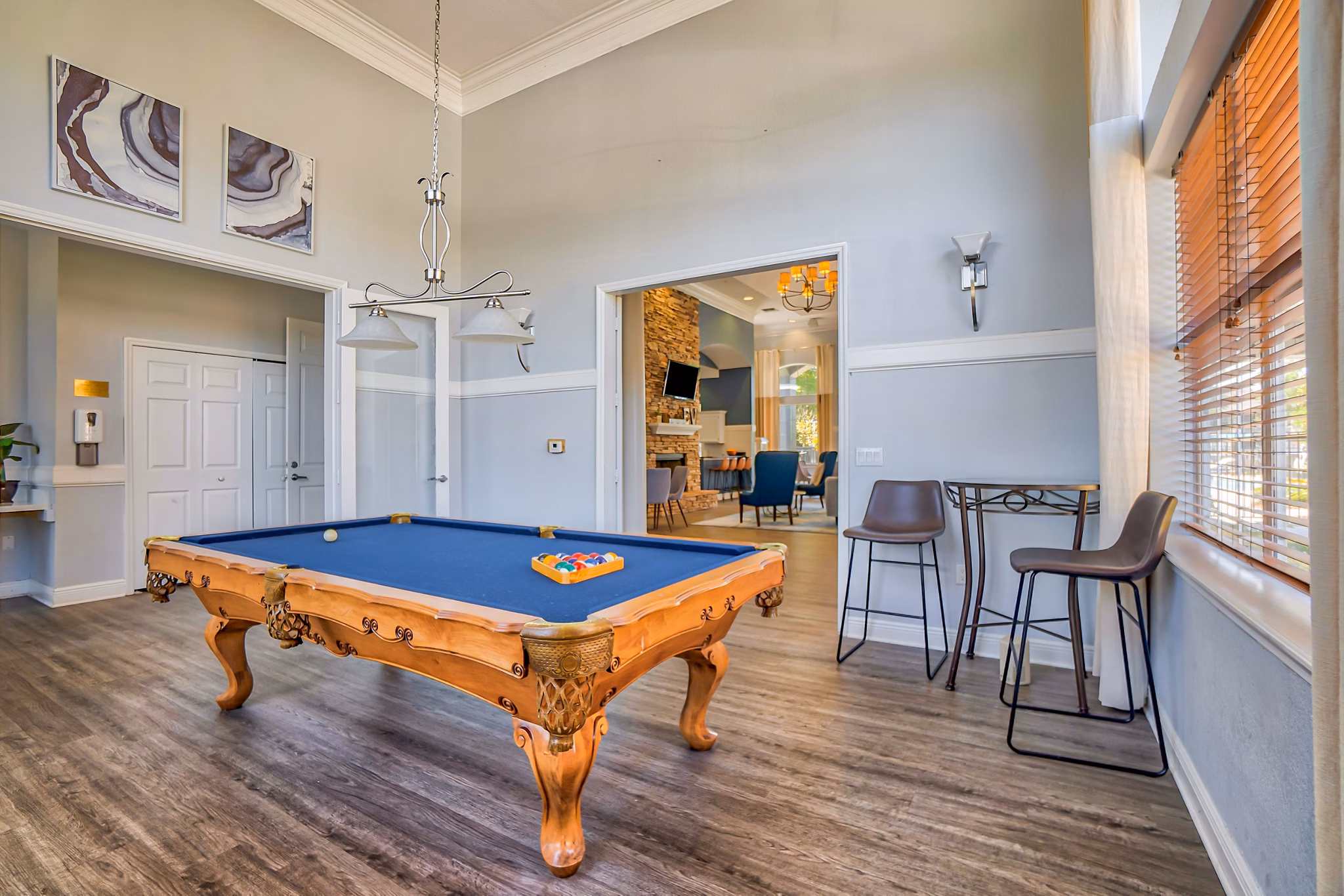 Vibrant game room featuring pool table and lounge seating at Elmhurst Village Apartments