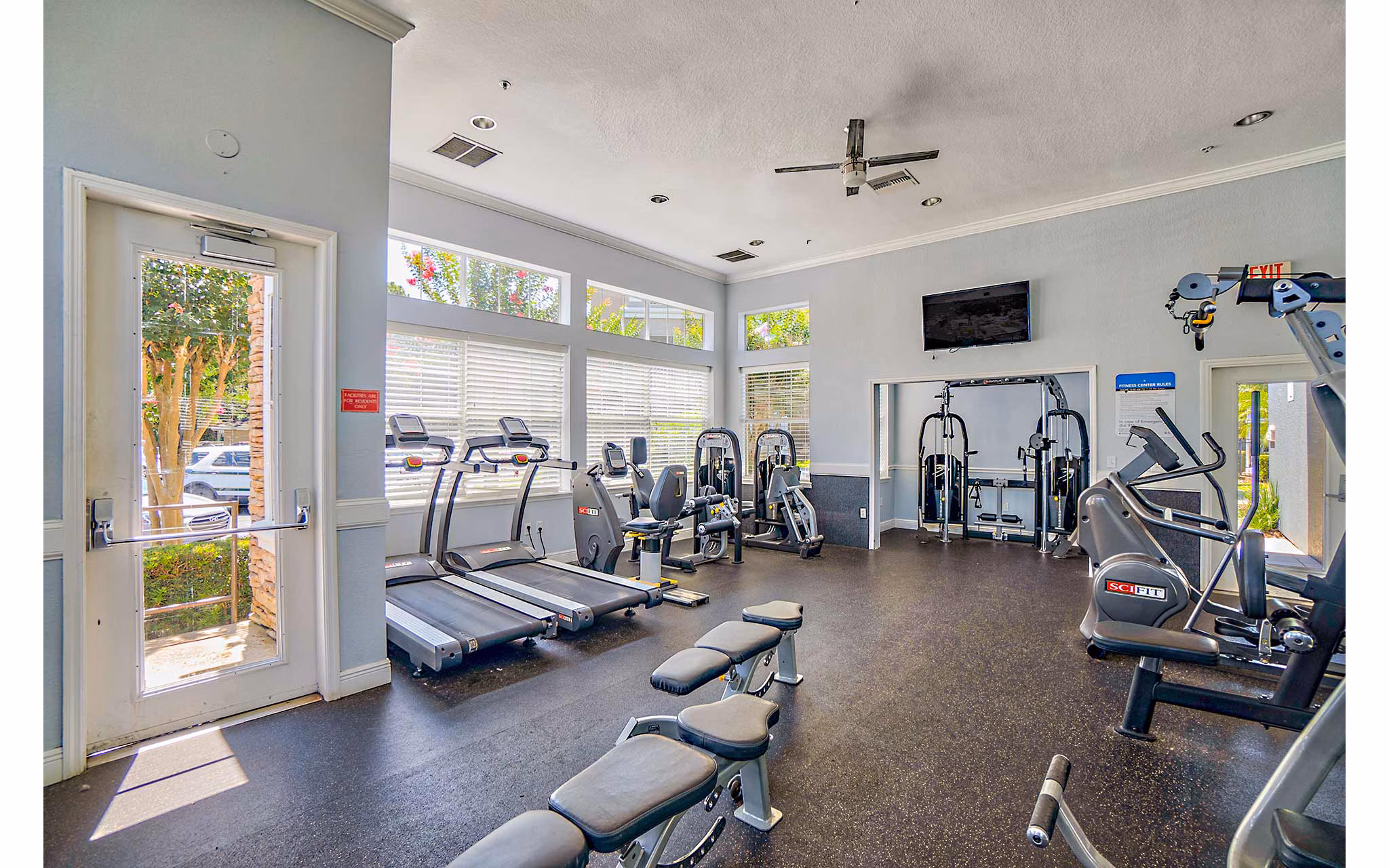 Elmhurst Village Apartments: Fully-equipped fitness center featuring modern exercise machines and spacious workout areas