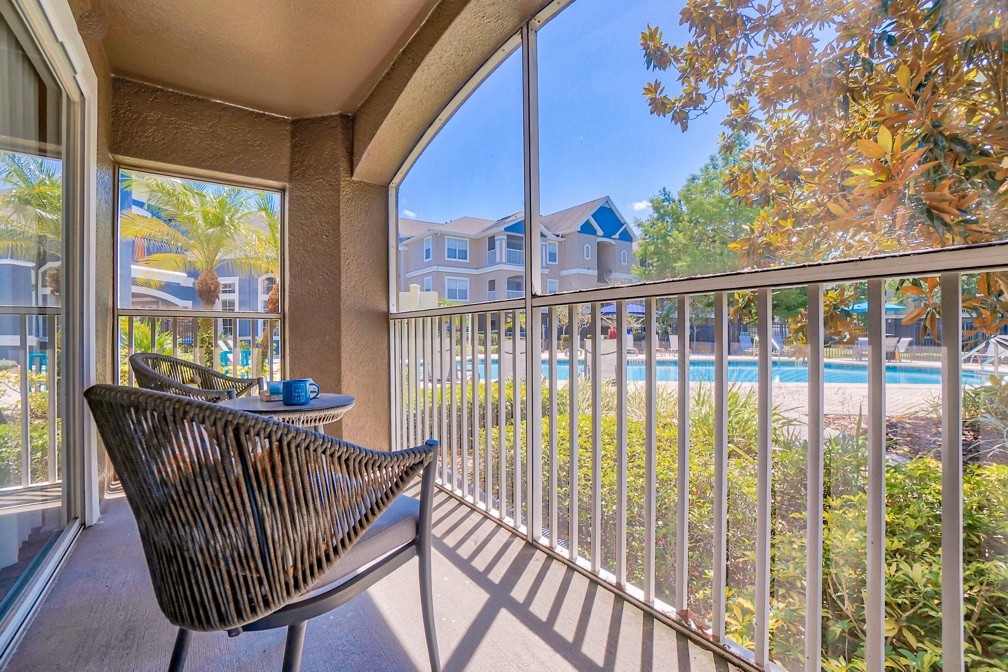 Spacious patio with outdoor seating at Elmhurst Village Apartments, ideal for relaxation and gatherings