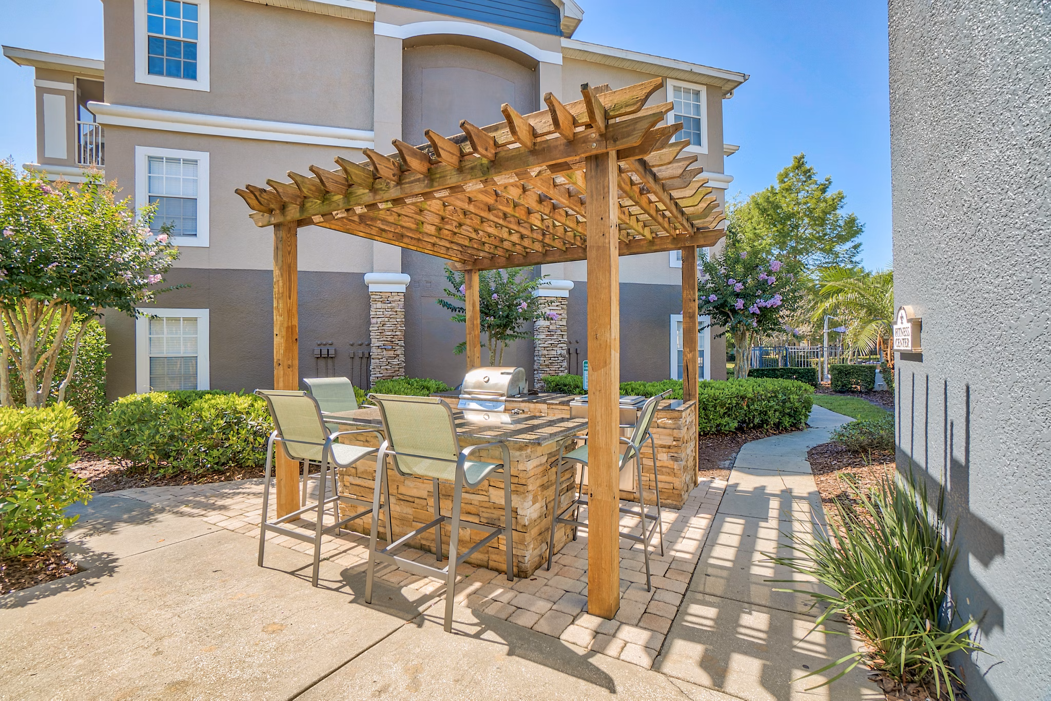 Grill area with modern barbecue stations at Elmhurst Village Apartments