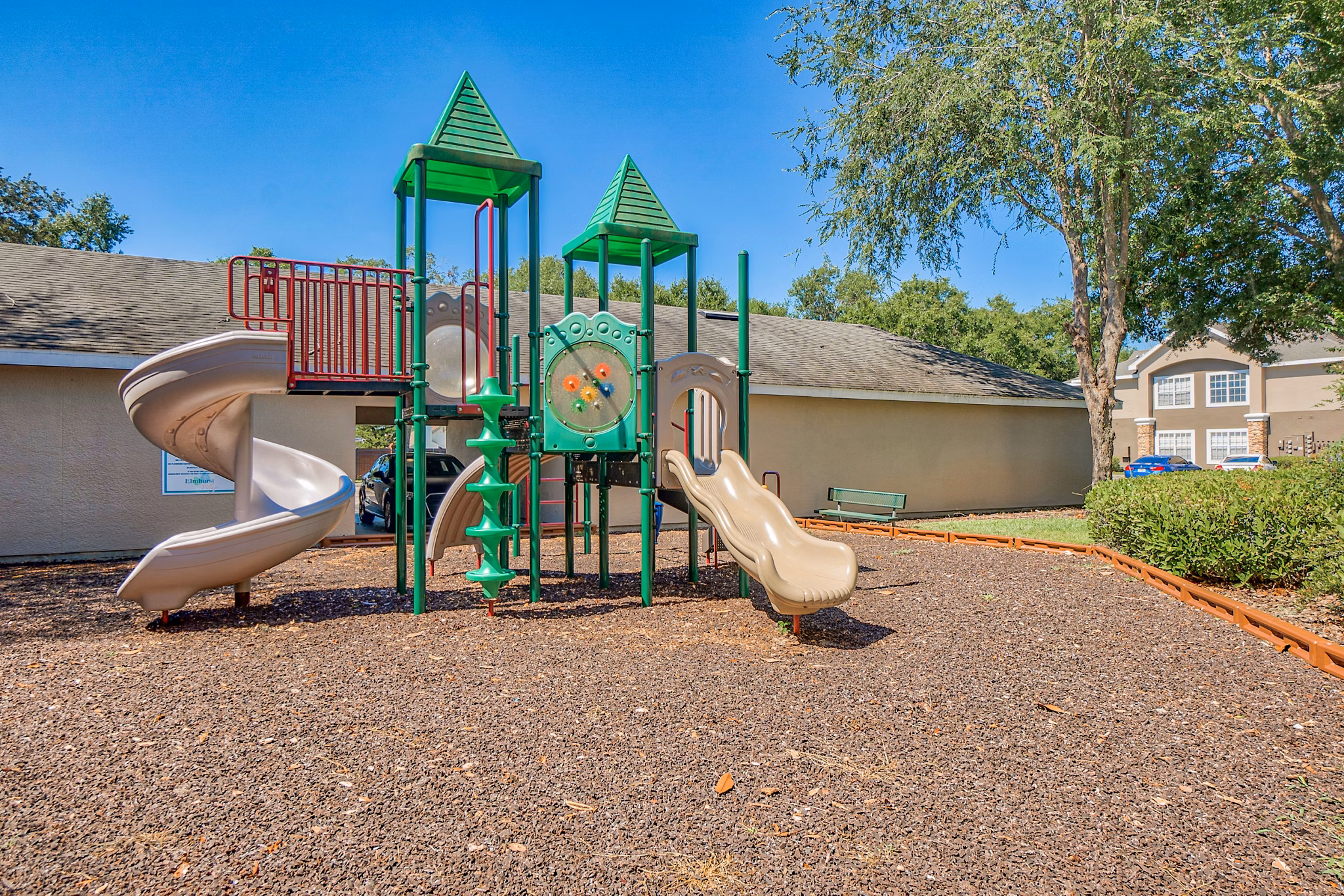 Playground with modern equipment at Elmhurst Village Apartments, a family-friendly feature in this vibrant residential community