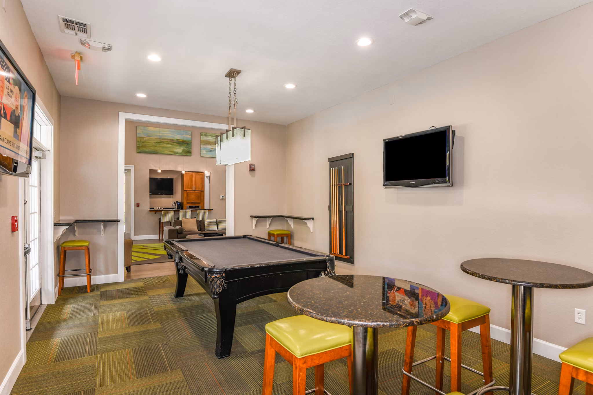 Game room with billiards and arcade games at Arbor Glen Apartments