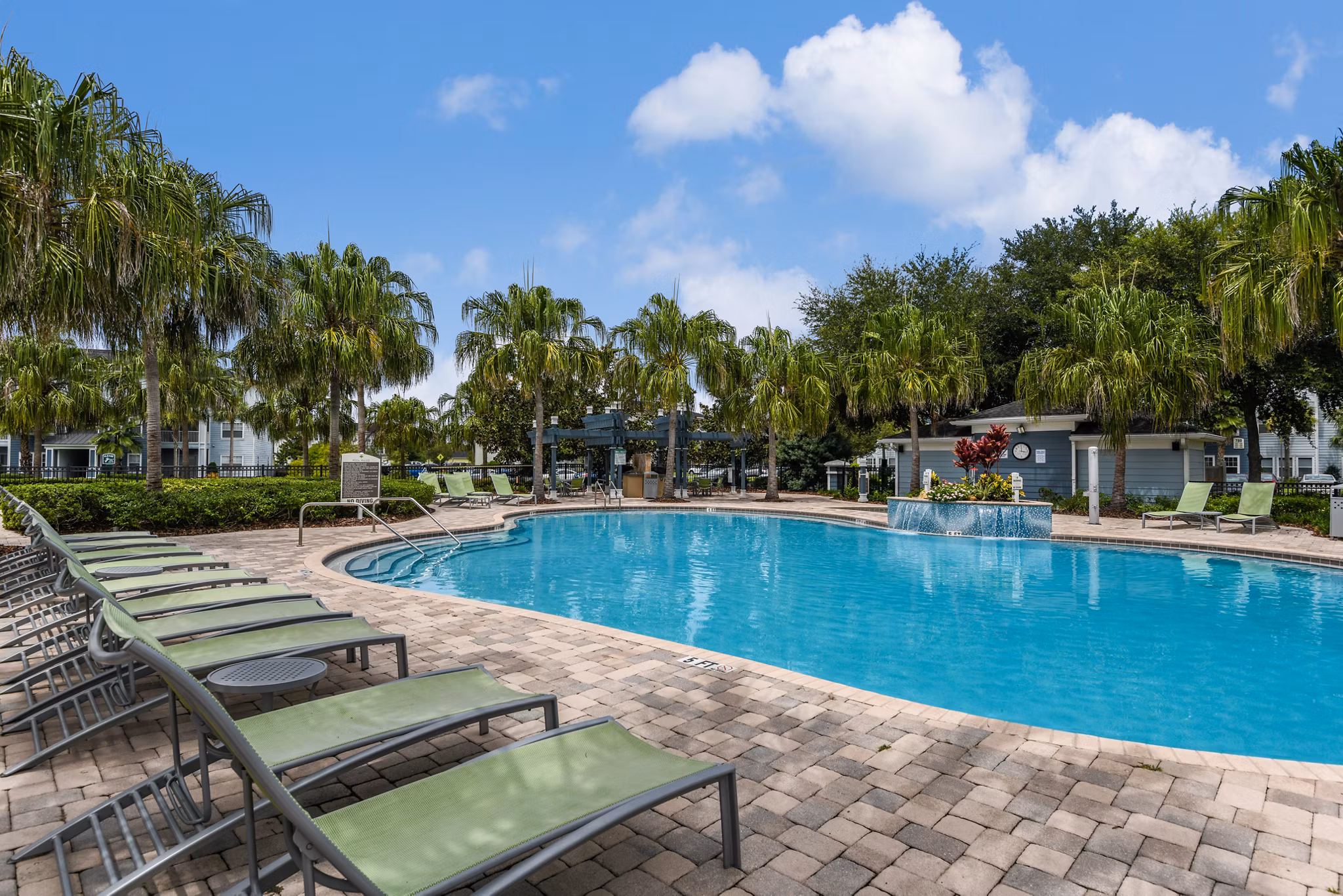 Luxurious pool with sun loungers at Arbor Glen Apartments for leisure and relaxation