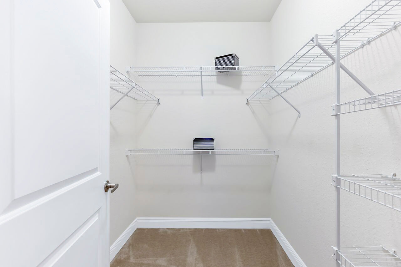 Walk-in closet with ample storage space at Trinity Club Apartments