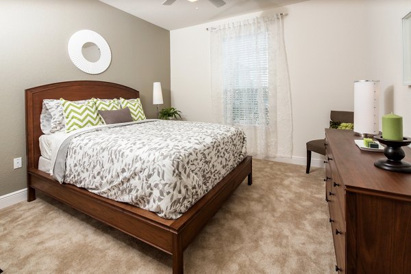 Spacious bedroom with modern decor at Trinity Club Apartments, luxury living provided by Greystar