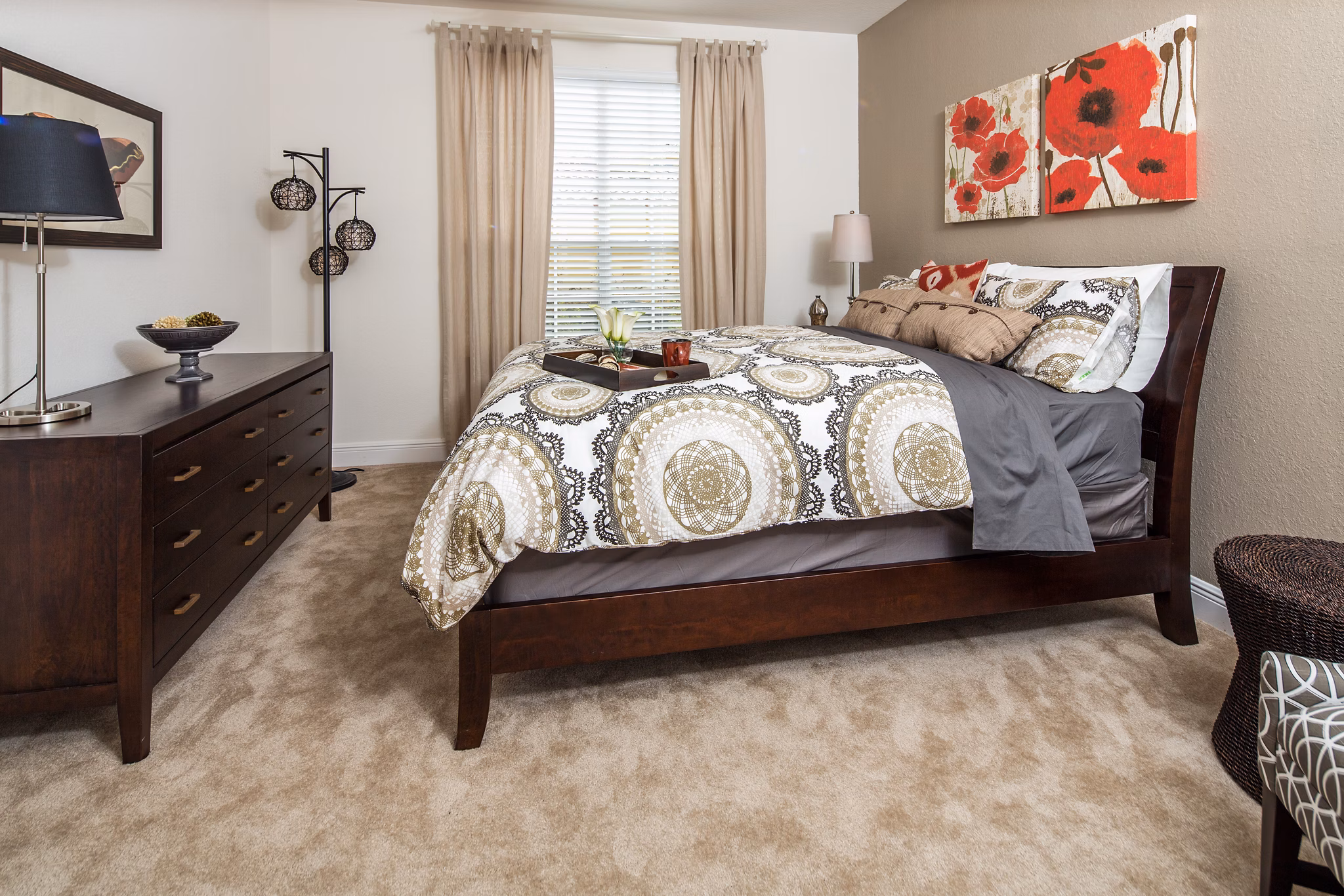 Bedroom with king-size bed, modern decor, and natural light at Trinity Club Apartments