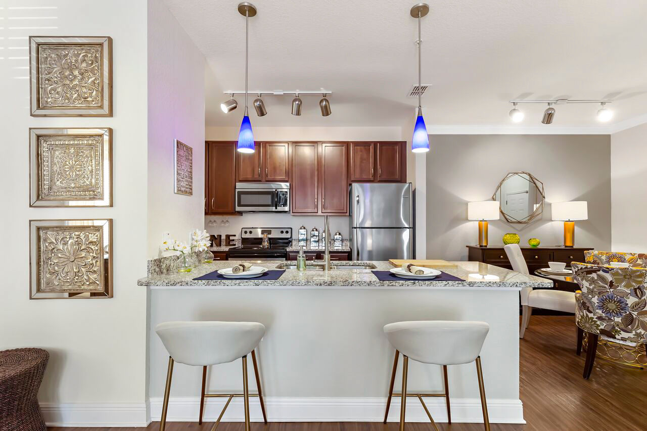 Luxury kitchen with stainless steel appliances and granite countertops at Trinity Club Apartments