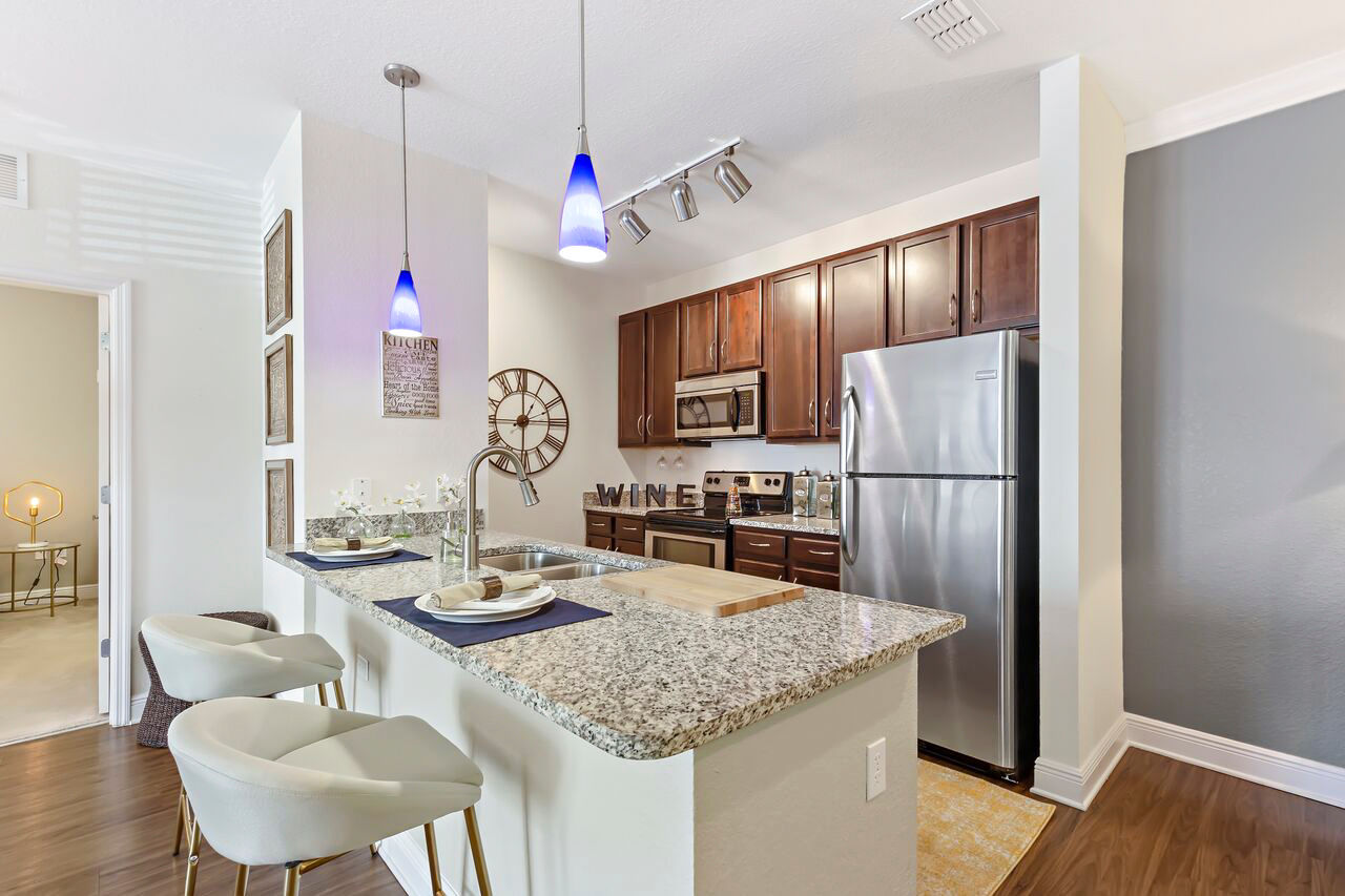 Modern kitchen with stainless steel appliances at Trinity Club Apartments