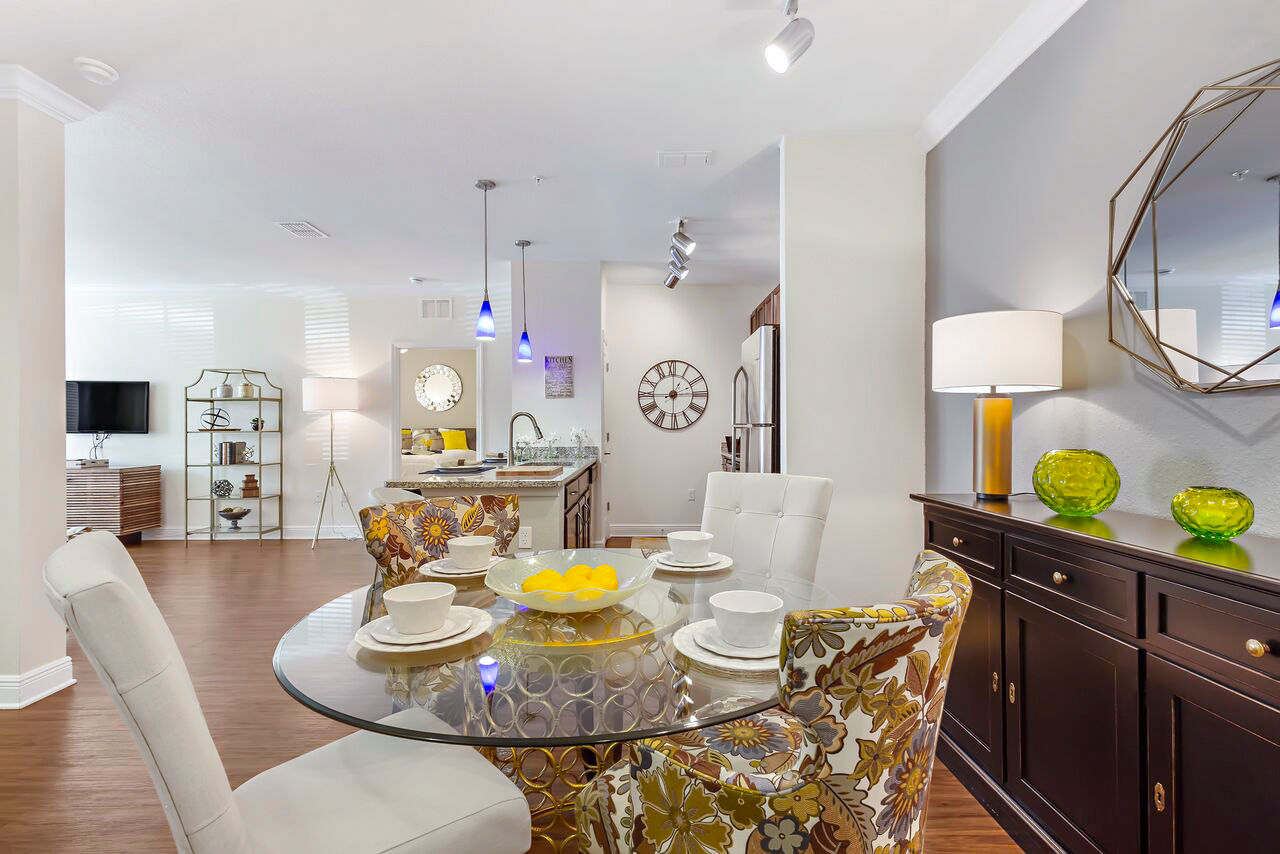 Dining room with modern furniture and elegant lighting at Trinity Club Apartments, a luxury Greystar property
