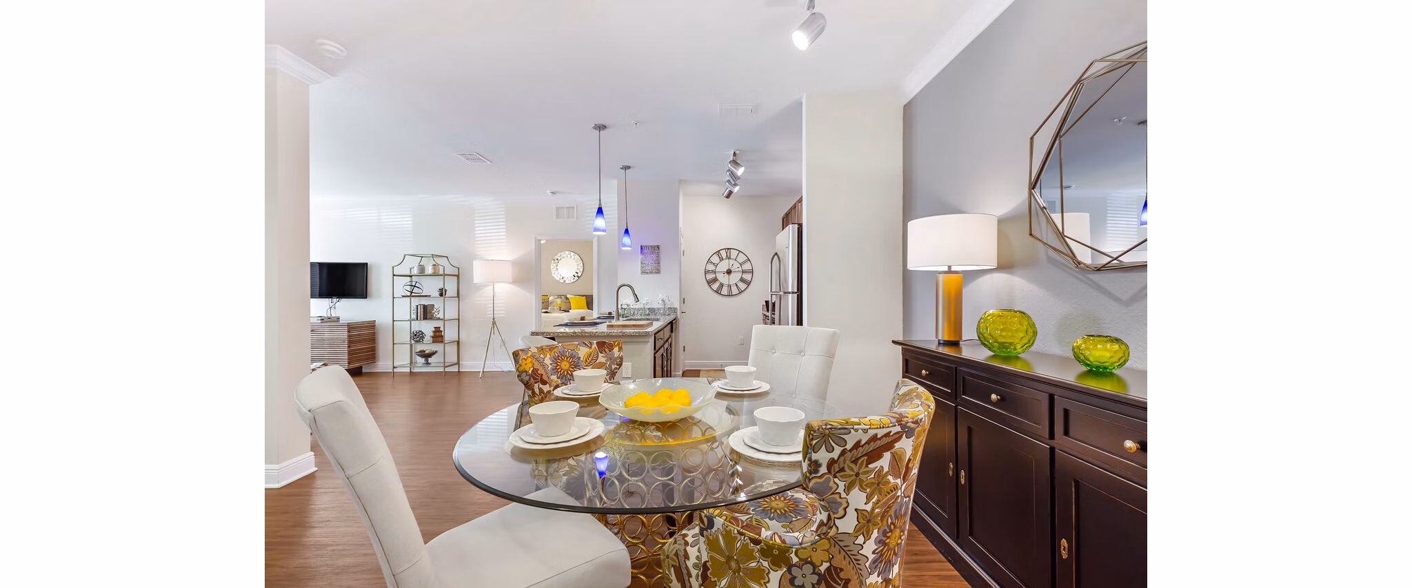 Dining room with modern furniture and elegant lighting at Trinity Club Apartments, a luxury Greystar property
