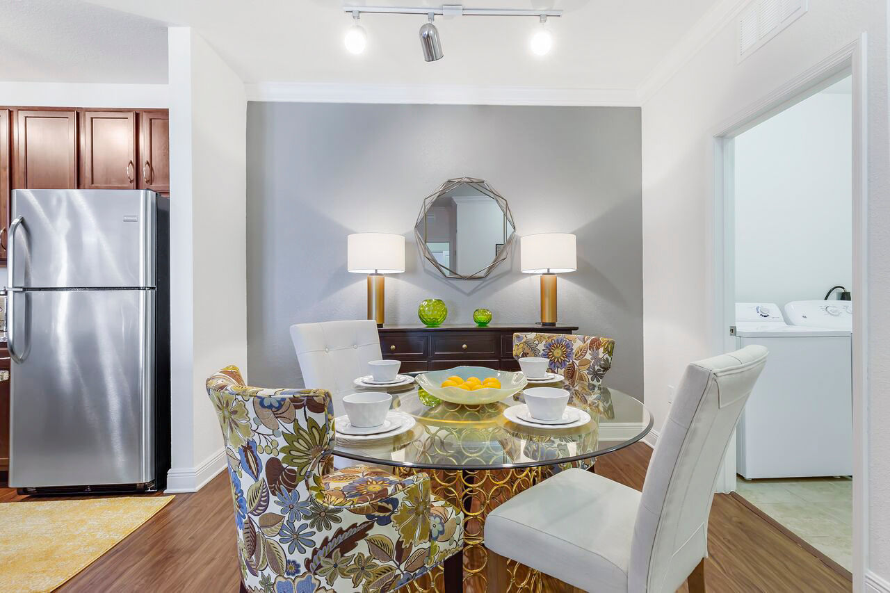 Dining room featuring elegant dining set and modern lighting at Trinity Club Apartments