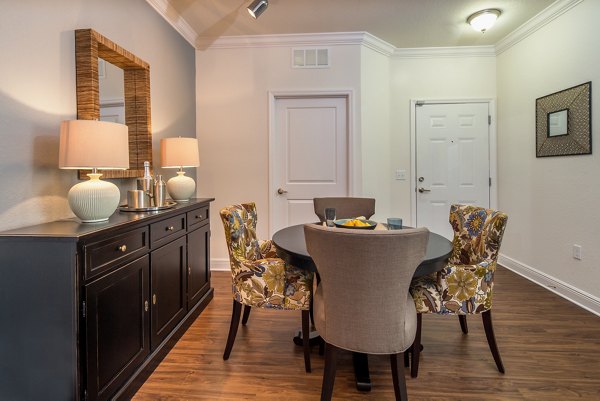 Dining area with sleek furniture and modern lighting in Trinity Club Apartments