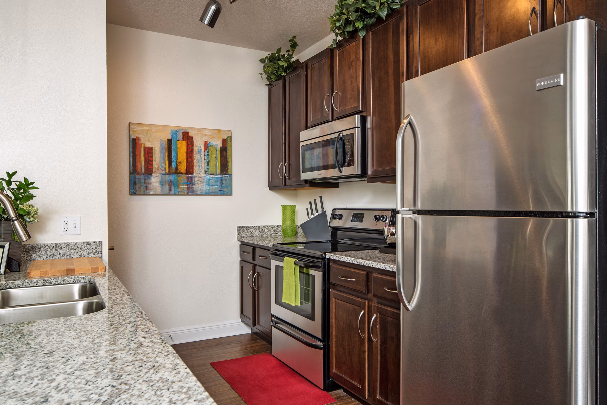 Modern kitchen with stainless steel appliances at Trinity Club Apartments