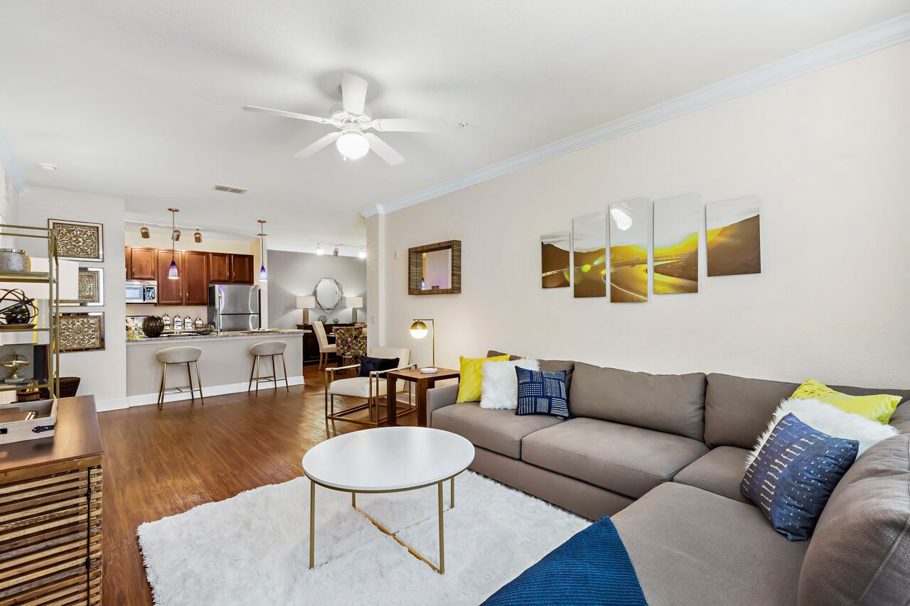 Spacious living room with modern furnishings at Trinity Club Apartments