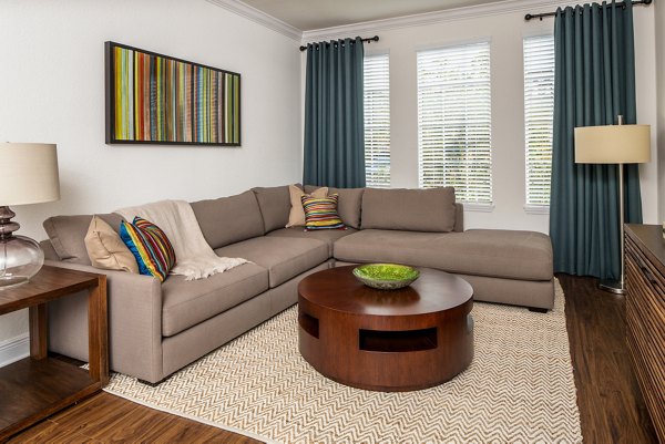 Spacious living room with modern decor at Trinity Club Apartments, featuring luxury design elements for comfortable living