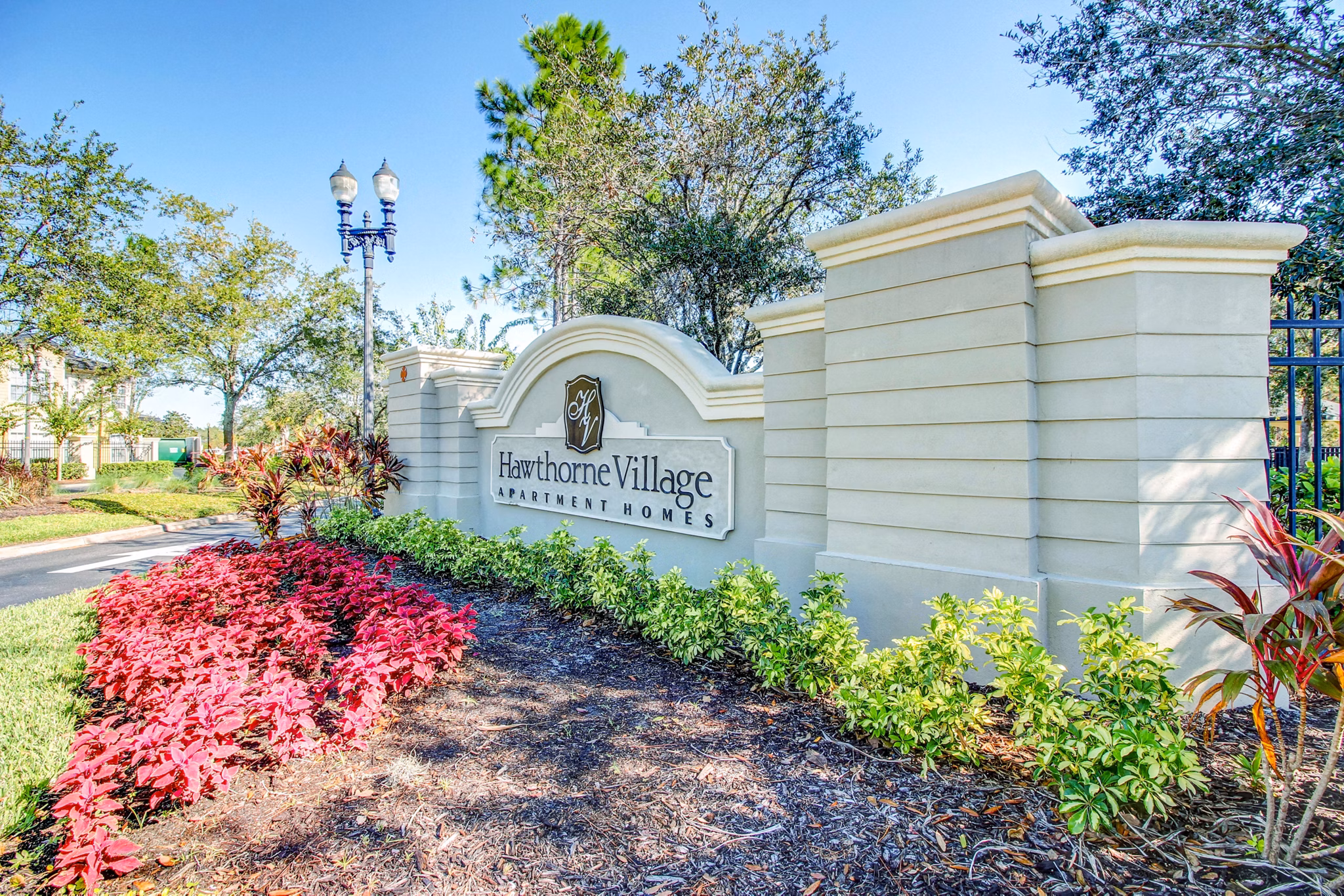 Hawthorne Village Apartments: Entrance signage highlighting luxury living in a serene community