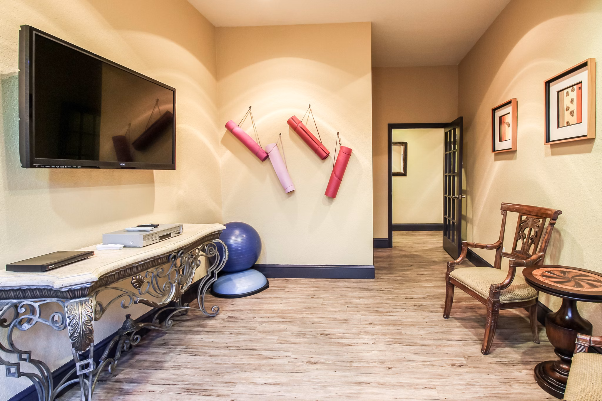 Yoga studio with large mirrors and natural light at Hawthorne Village Apartments