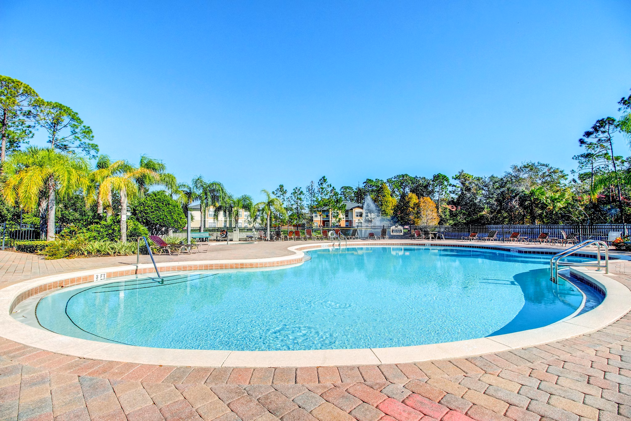 Resort-style pool area at Hawthorne Village Apartments, luxury community offering relaxation and leisure in a serene setting