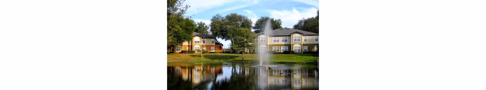 Hawthorne Groves Apartments: Scenic view, modern architecture nestled in lush greenery