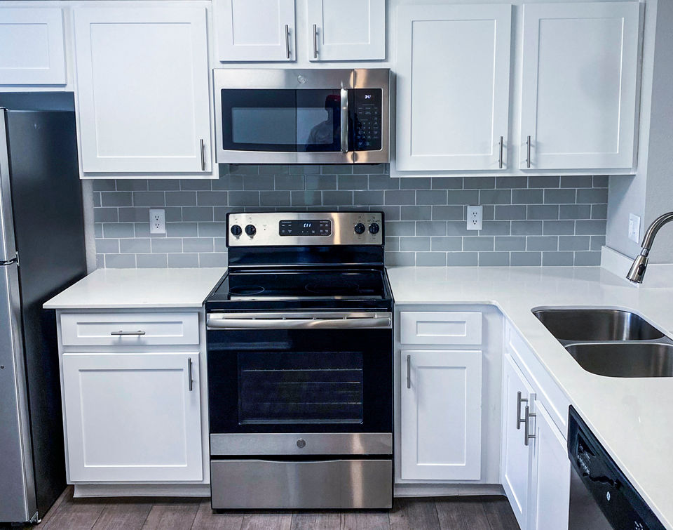 Modern kitchen with stainless steel appliances at The Crest at Altamonte Apartments