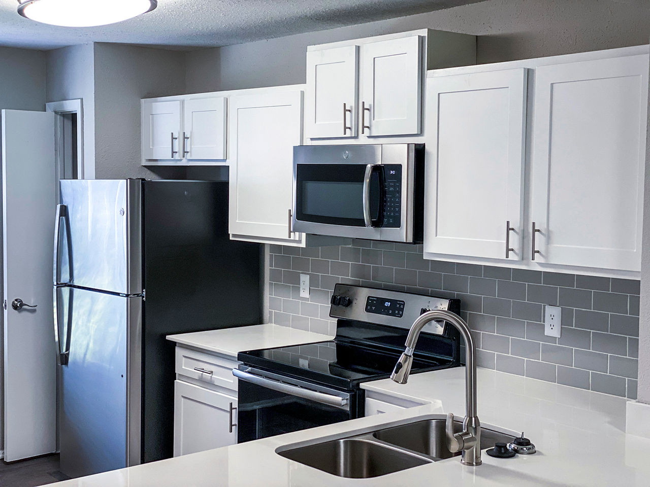 Modern kitchen with stainless steel appliances at The Crest at Altamonte Apartments