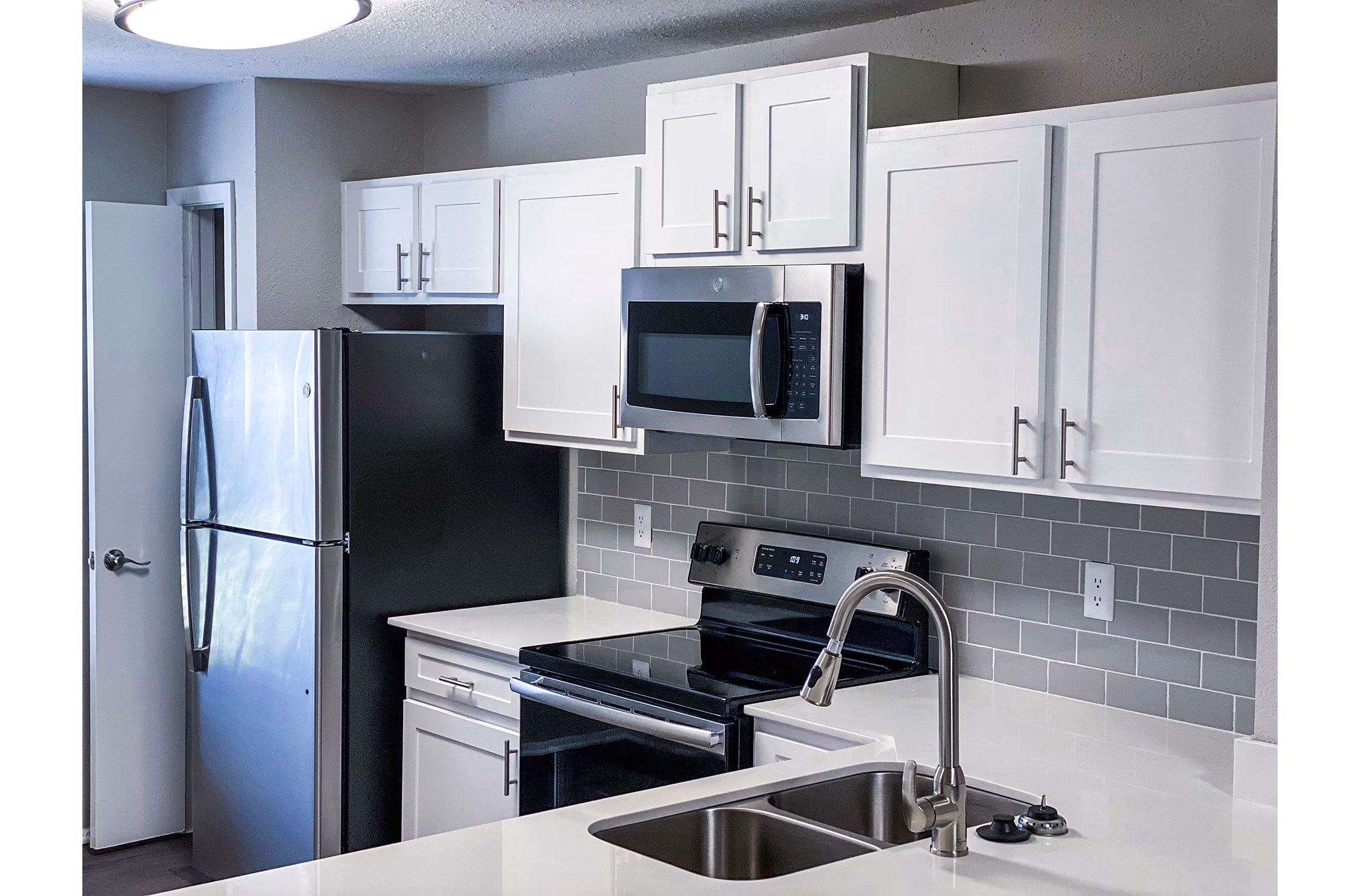Modern kitchen with stainless steel appliances at The Crest at Altamonte Apartments