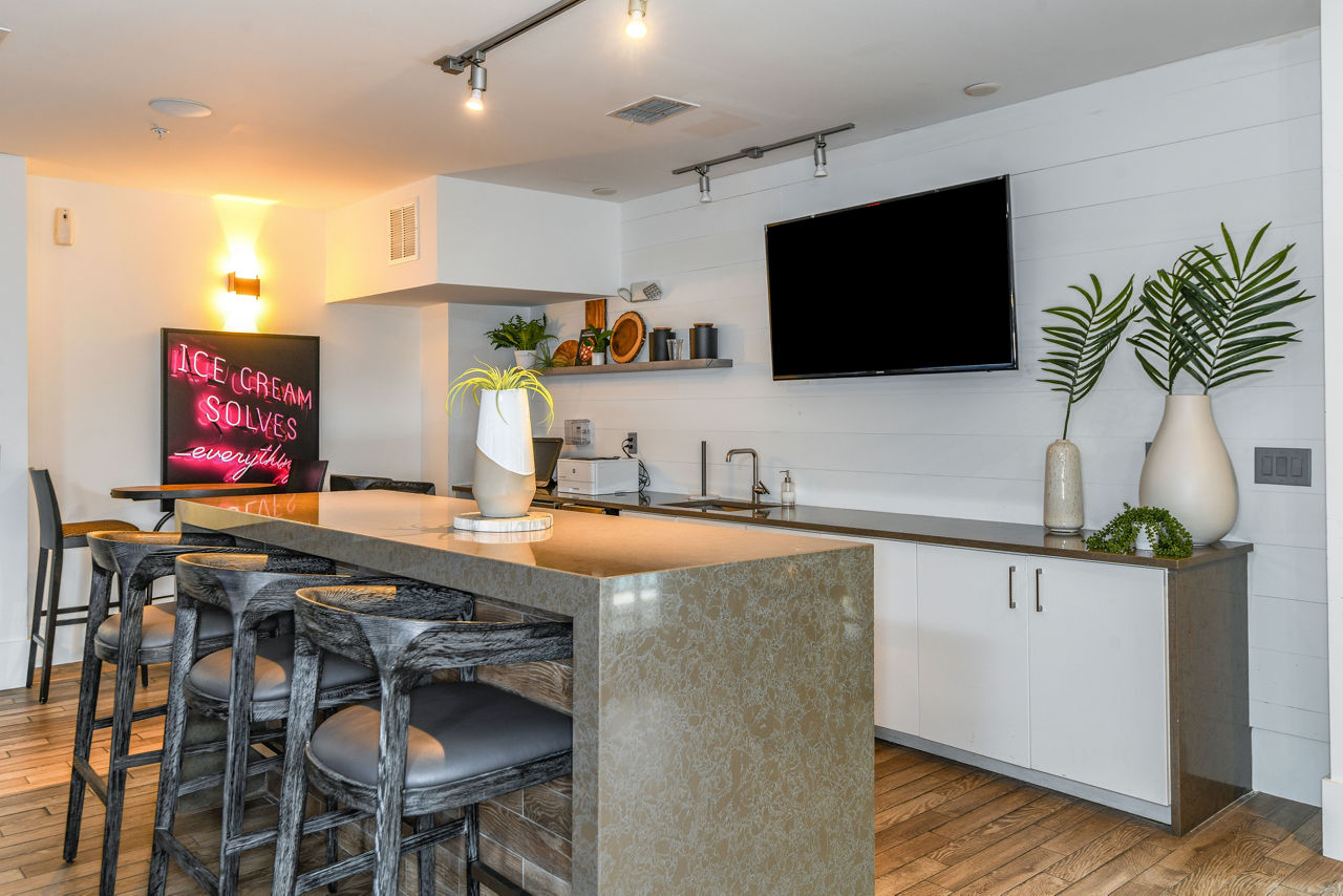 Clubhouse featuring modern design and seating at The Gallery at Mills Park Apartments in Orlando, Florida