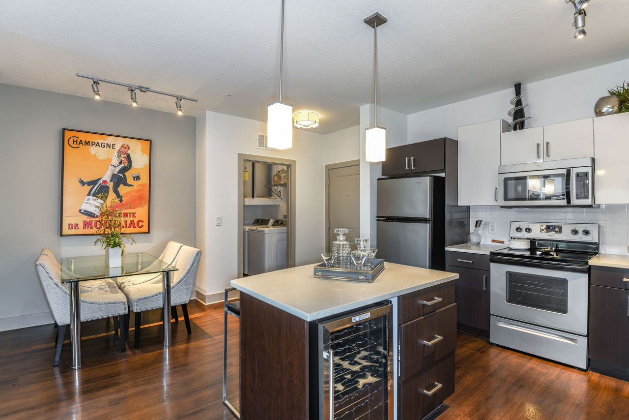 Dining area featuring elegant table setting and modern lighting at The Gallery at Mills Park Apartments