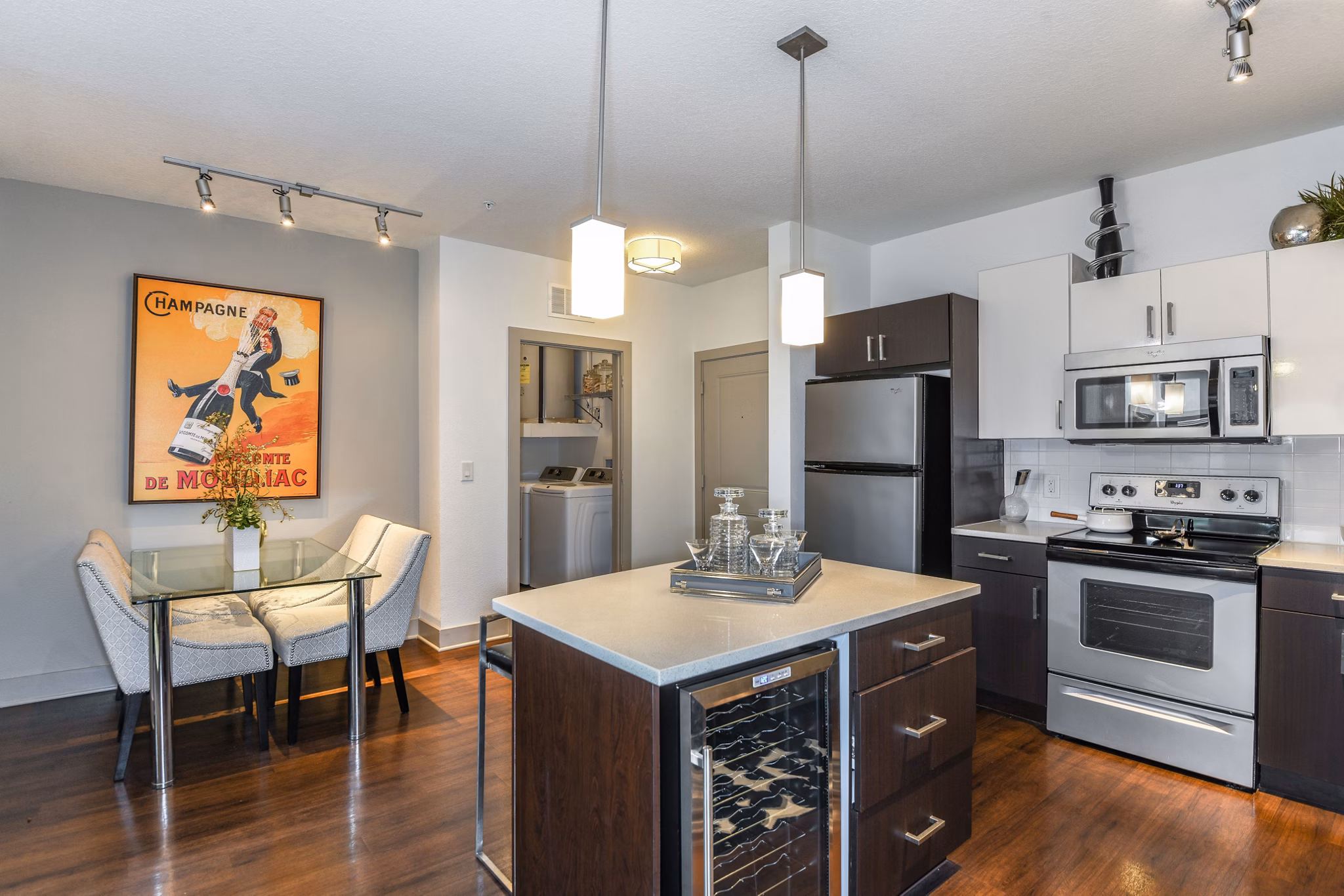 Dining area featuring elegant table setting and modern lighting at The Gallery at Mills Park Apartments