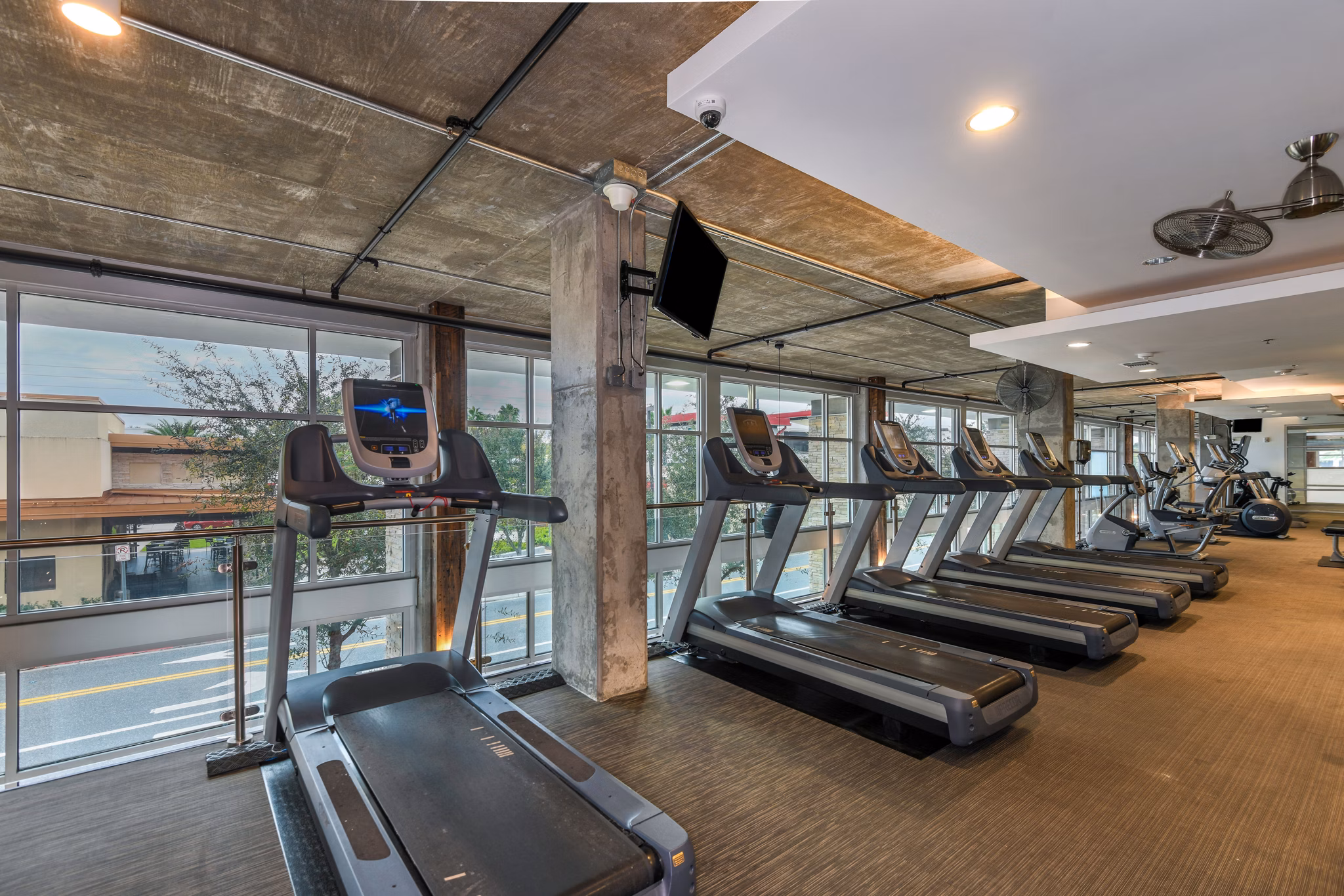 Modern fitness center with advanced equipment at The Gallery at Mills Park Apartments, offering luxury amenities for an active lifestyle