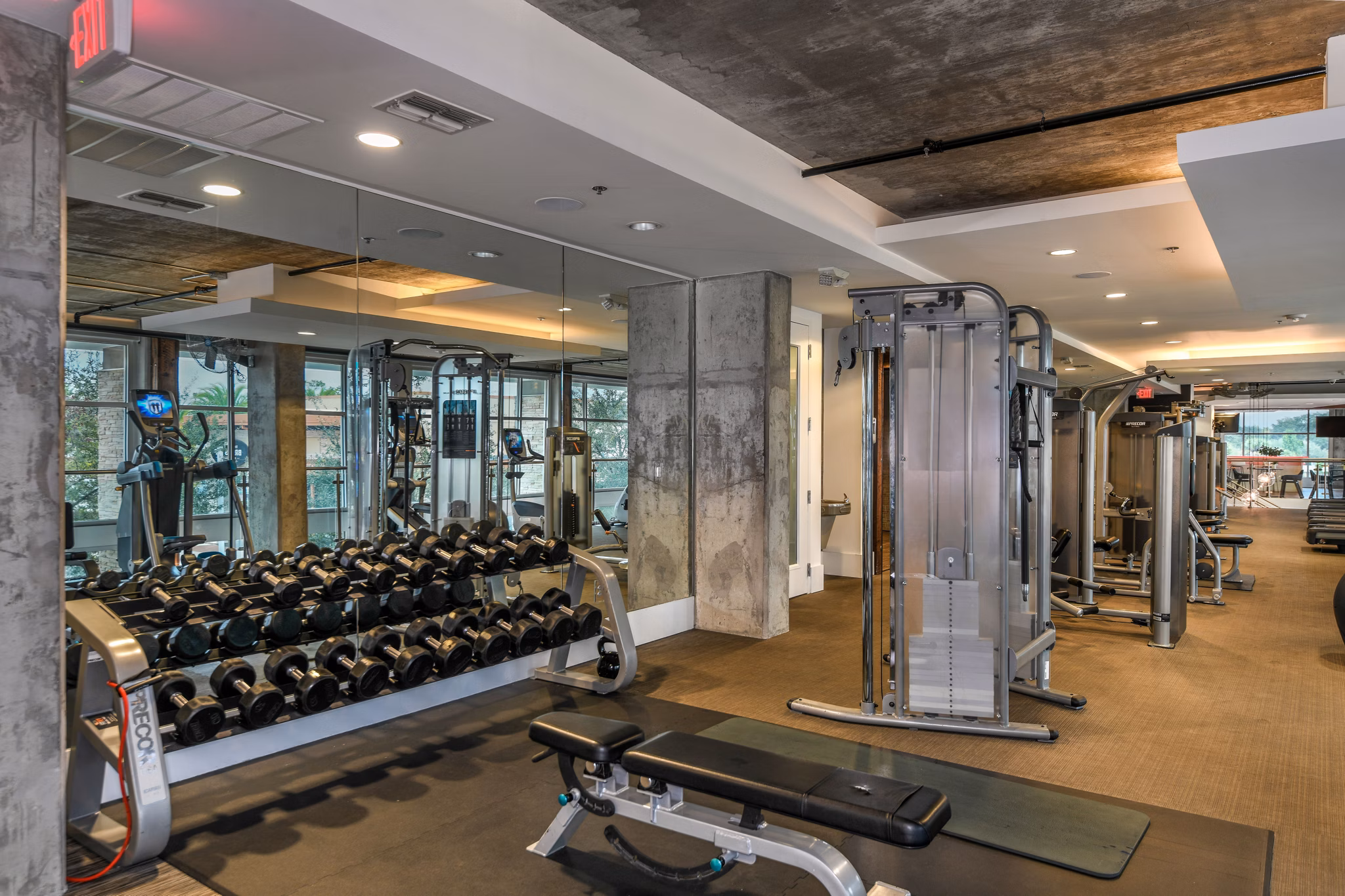 Modern fitness center with state-of-the-art equipment at The Gallery at Mills Park Apartments