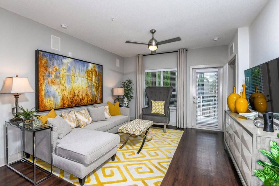 Spacious living room with modern decor in The Gallery at Mills Park Apartments, offering luxury living in a vibrant community setting