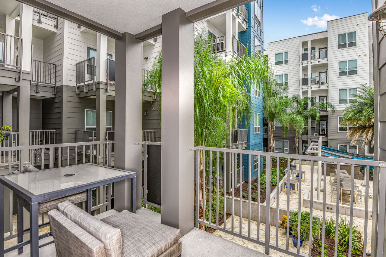 Modern patio at The Gallery at Mills Park Apartments featuring stylish seating and lush landscaping