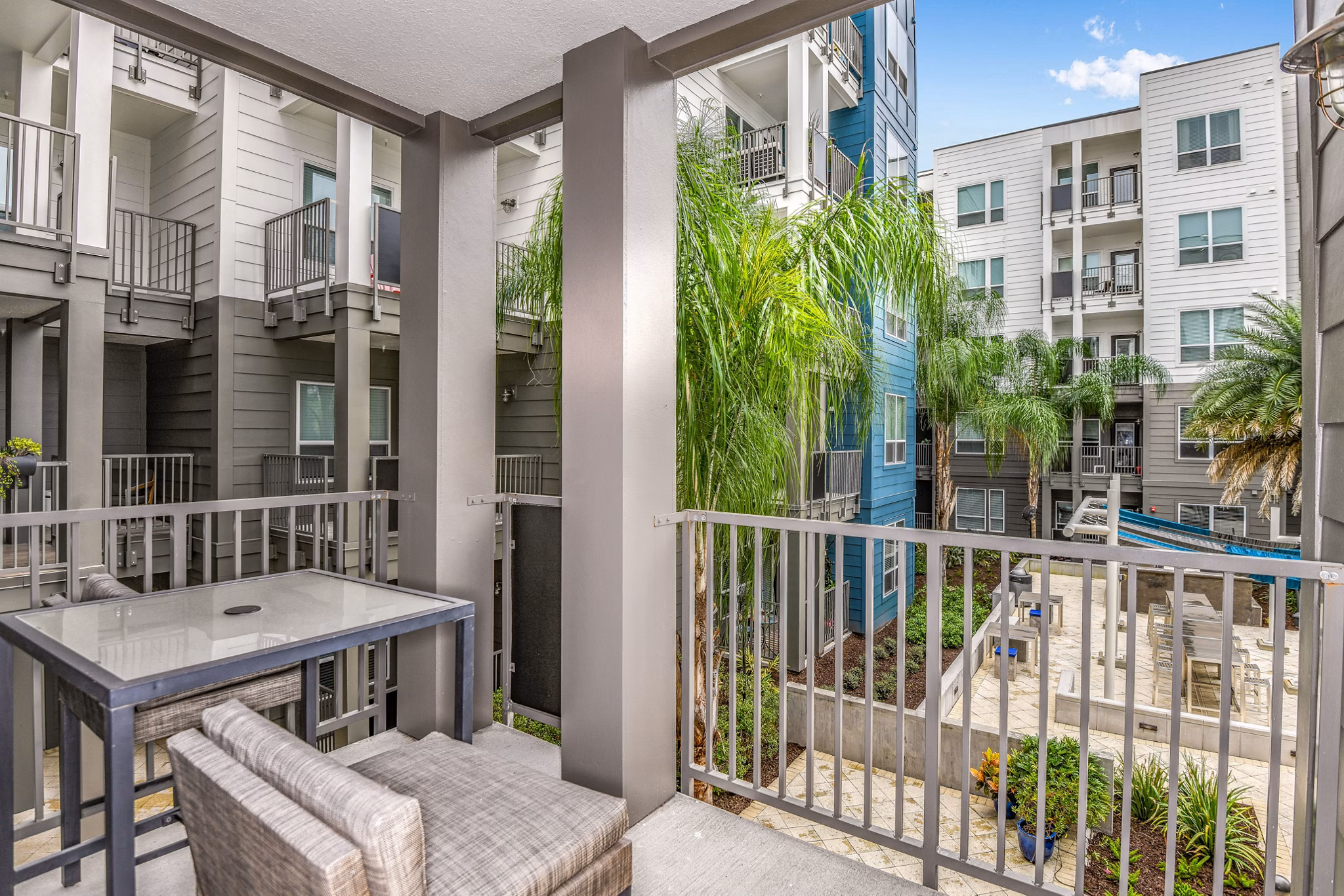Modern patio at The Gallery at Mills Park Apartments featuring stylish seating and lush landscaping