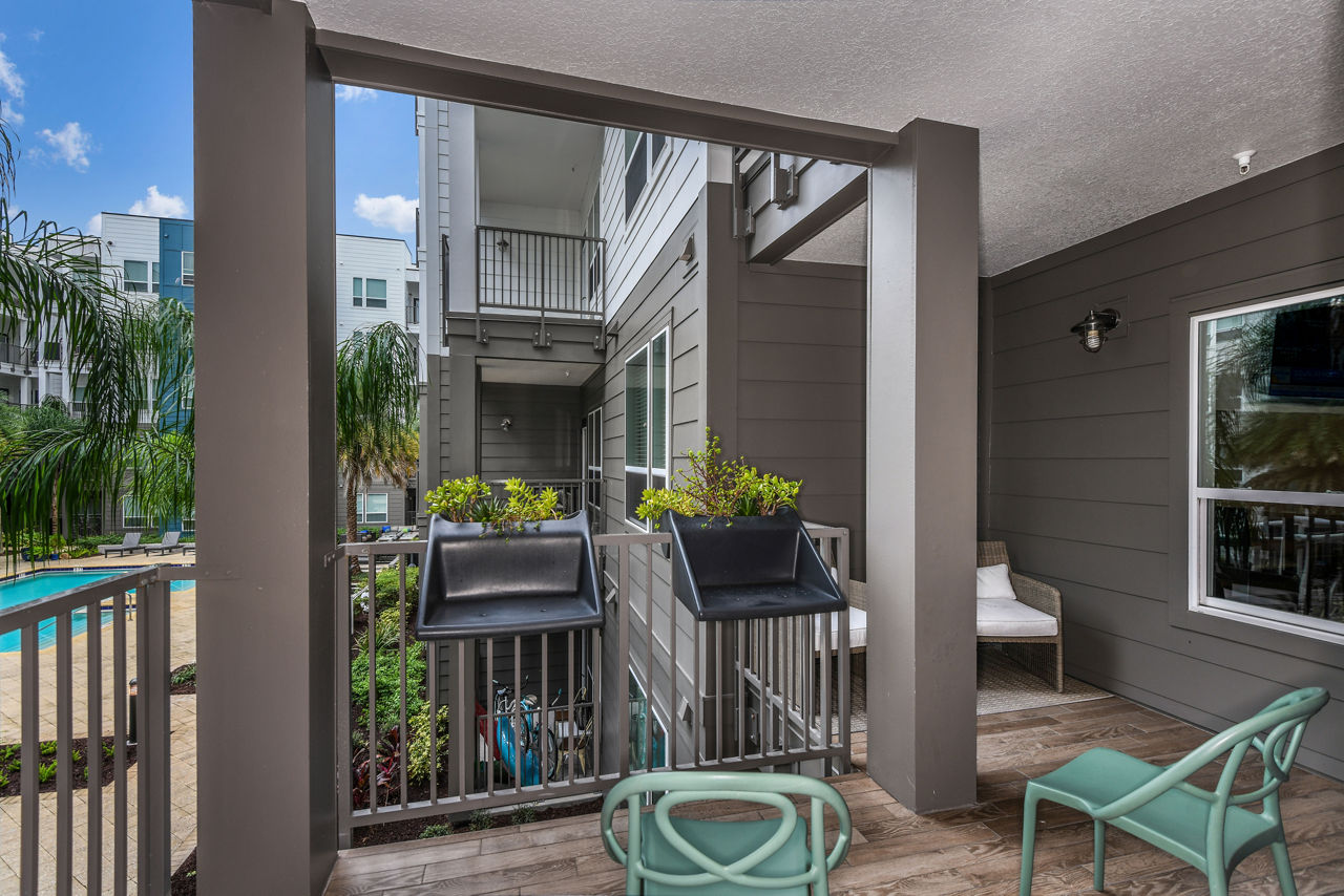 Charming patio with comfortable seating at The Gallery at Mills Park Apartments, perfect for relaxation and social gatherings