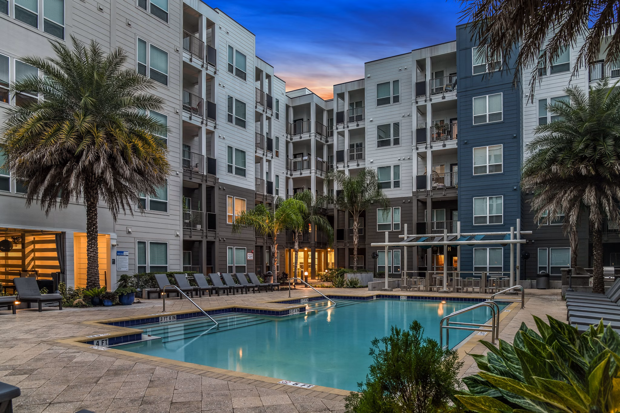 Resort-style swimming pool at The Gallery at Mills Park Apartments, offering relaxation and leisure in a luxury residential setting