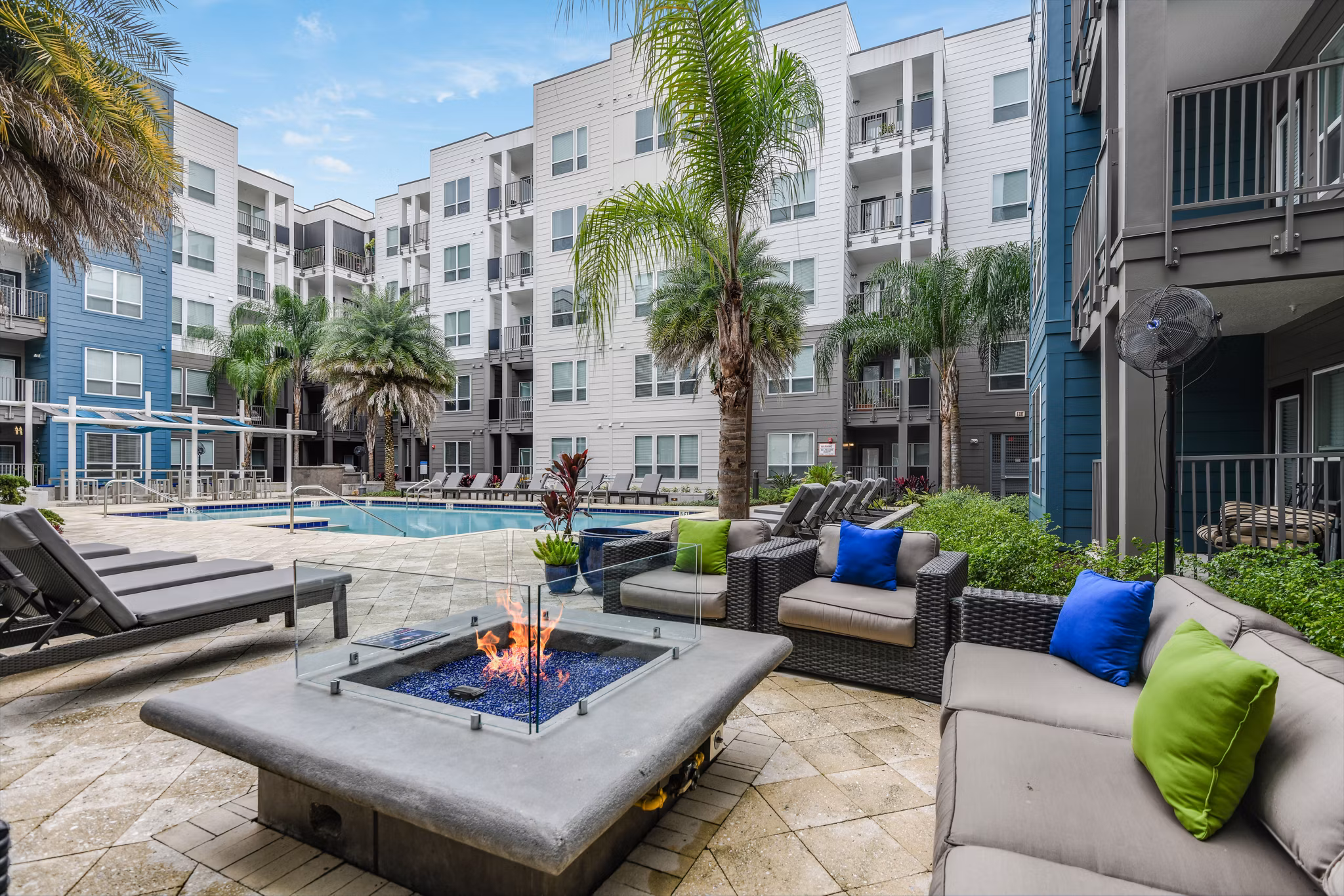 Fire pit surrounded by cozy seating at The Gallery at Mills Park Apartments Ideal for outdoor relaxation and socializing in a luxury setting