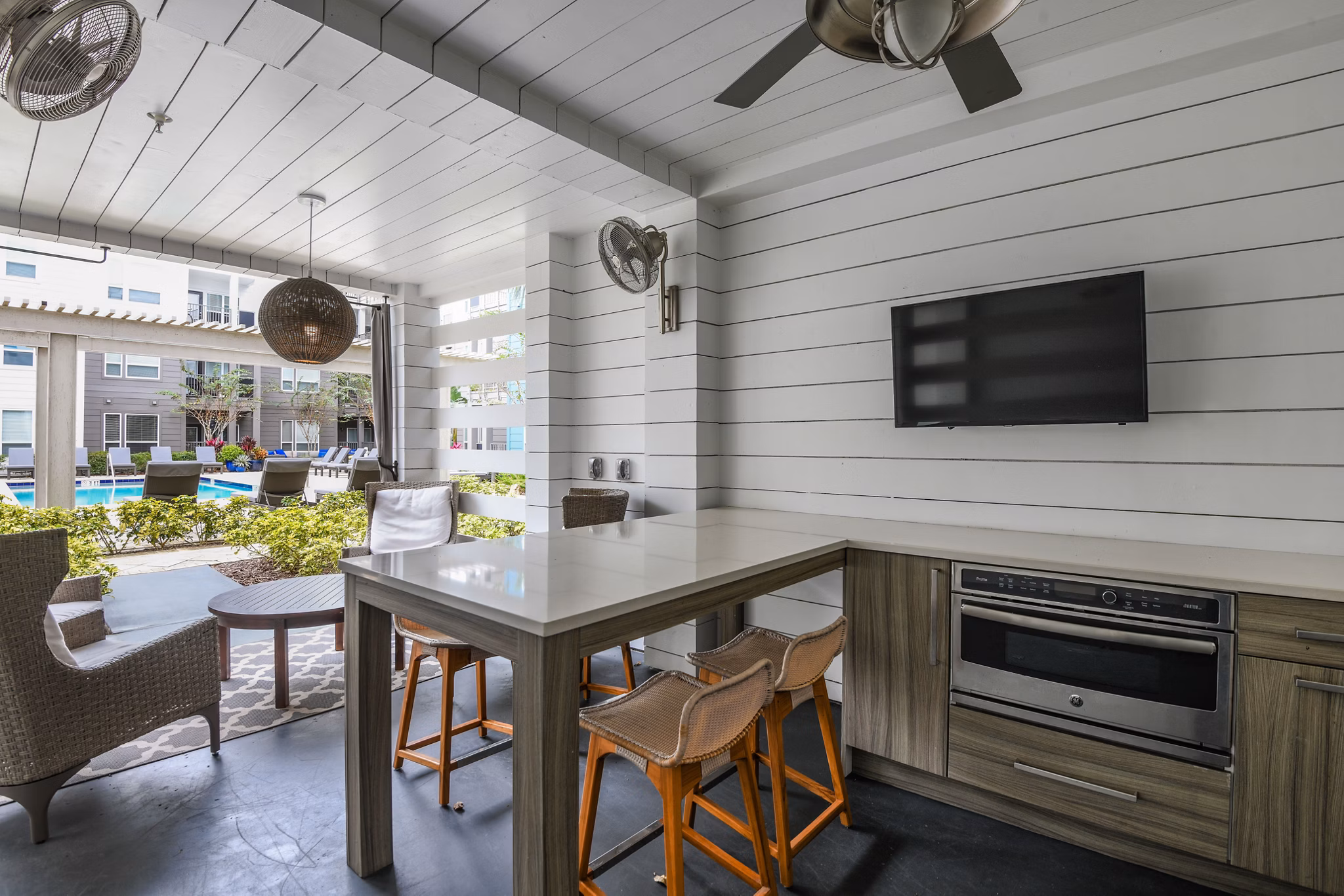 Outdoor grill area at The Gallery at Mills Park Apartments featuring state-of-the-art equipment and seating for residents to enjoy social gatherings