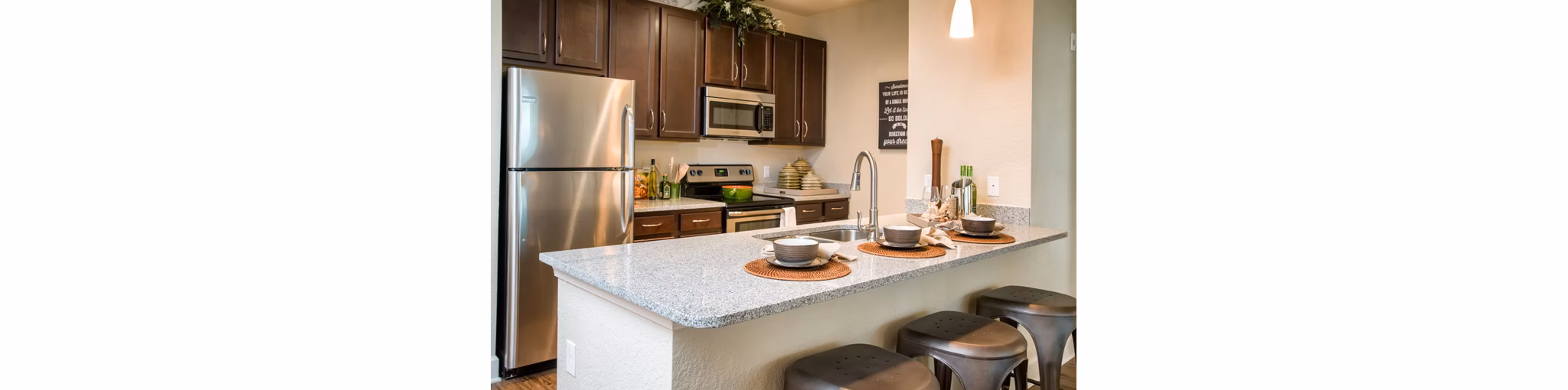 Modern kitchen with stainless steel appliances at Trinity Exchange Luxury Apartments