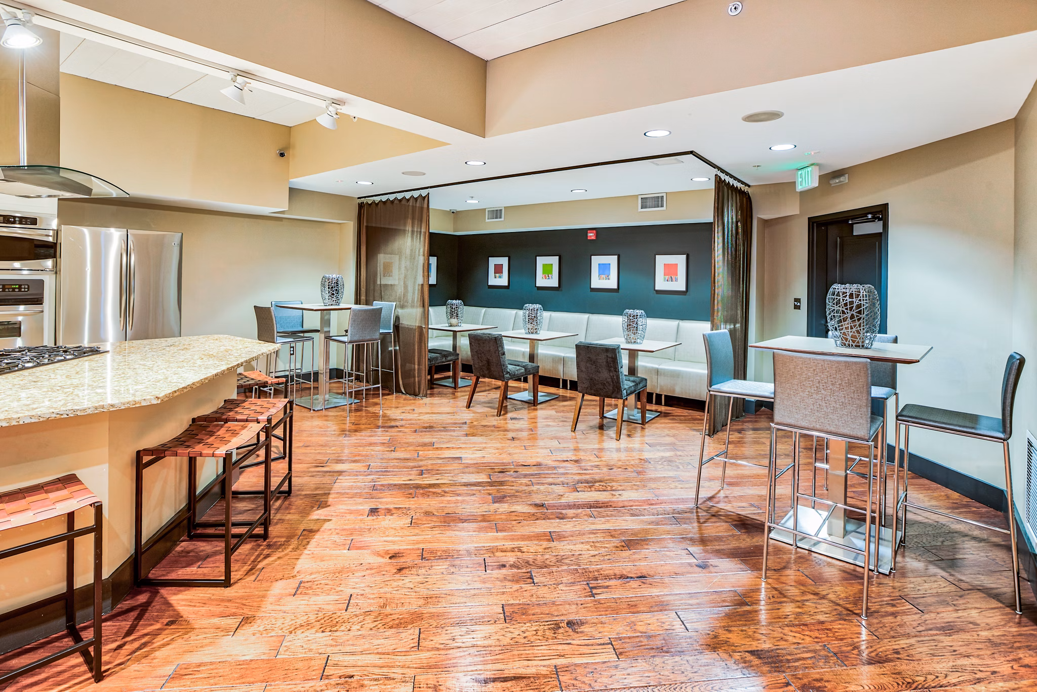 Clubhouse kitchen featuring modern appliances and island seating at McHenry Row Apartments, offering luxury living in an upscale environment