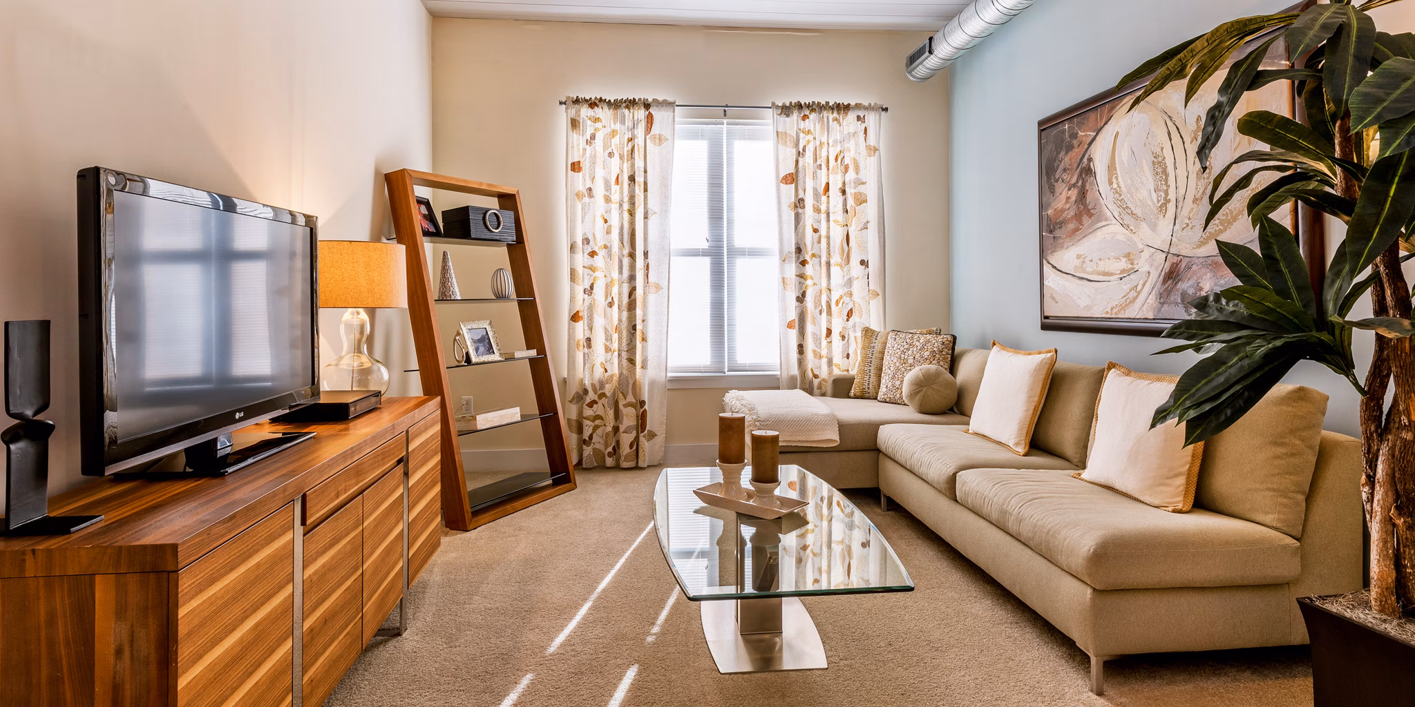 Modern living room with a cozy sofa, glass coffee table, and stylish decor in luxury apartment