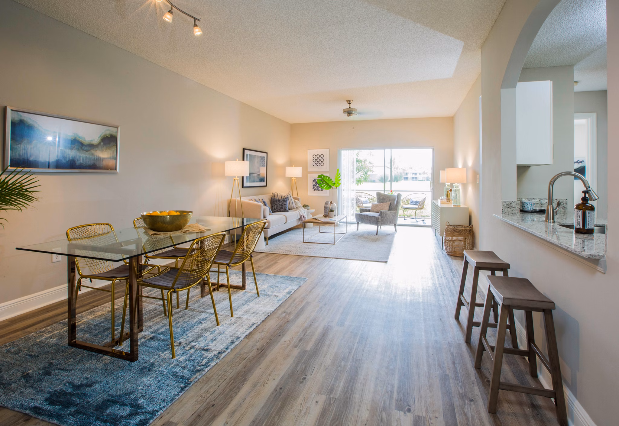 Dining area with elegant wooden table and modern lighting at Citation Club Apartments, luxurious living by Greystar